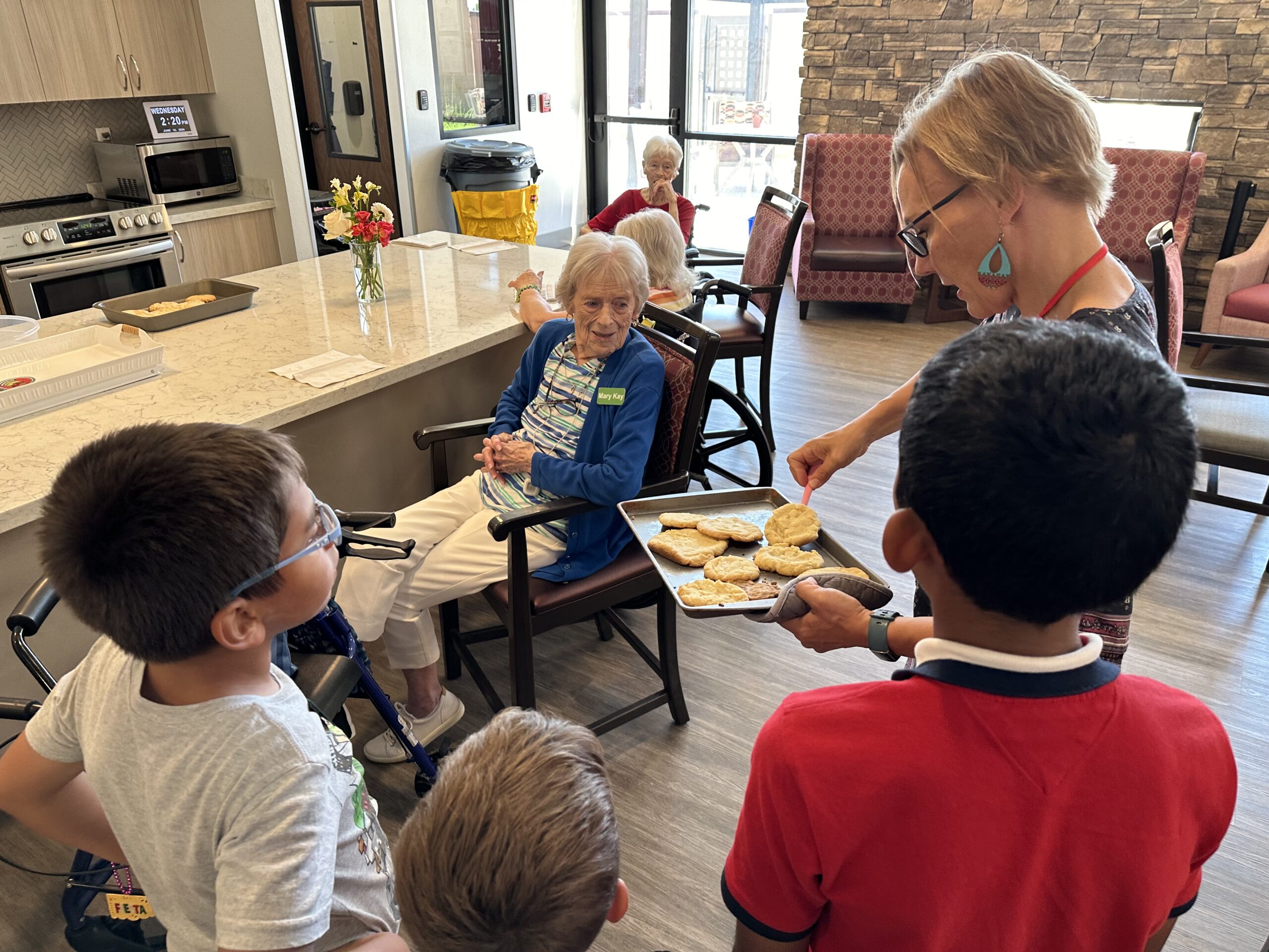 Bridging Generations: The Benefits of Intergenerational Programs in Senior Living Children and elderly residents baking cookies at Amaran.