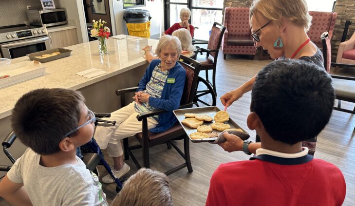 Children and elderly residents baking cookies at Amaran.