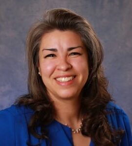 jaime_buenrostro Headshot of Carla Jaime-Buenrostro smiling, wearing blue and standing in front of a wall.